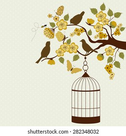 Bird cage hanging from floral branch