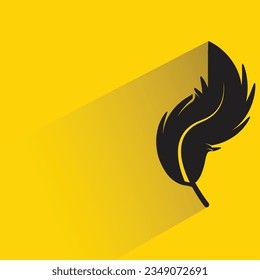 bird feather with shadow on yellow background