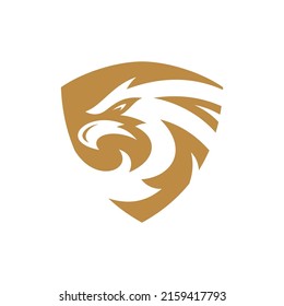 Bird head silhouette and shield logo design. Eagle, falcon or hawk badge emblem vector icon