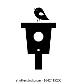 Bird houses with a bird on top of it black vector silhouette isolated vector illustration