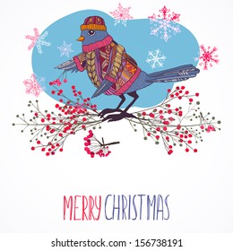 Bird in knitted sweater and hat with berries