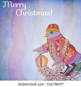 Bird in knitted sweater and hat with christmas ball