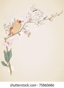bird sitting on a branch of blossoming tree