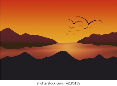 Birds fly into the sun at sunset on a mountain lake
