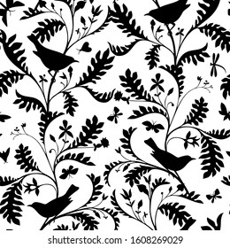 Birds on the tree branches. Seamless pattern. Black animal silhouettes in vintage style on a white. Nature motif with small birds, boughs with leaves. Textile fashion design for fabric and wrapping.