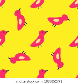 Birds are pink on a yellow background. Scandinavian simple pattern with birds. For textiles, background, packaging paper, fabric, wallpaper.
