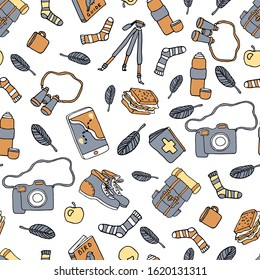 Birdwatching and ornithology concept. Bird watching seamless pattern. Vector illustration with birdwatcher equipment. Guide, camera, backpack, snack, boots, first aid kit, bird binocular
