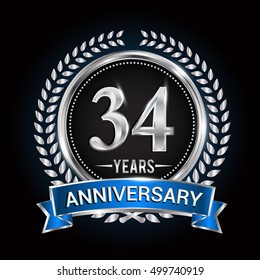 Birthday celebration logo 34 years with wreath, laurel, blue ribbon and silver ring
