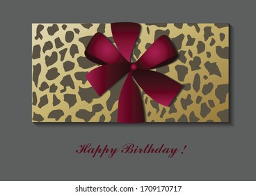 BIrthday gift with red ribbon and leopard paper texture
