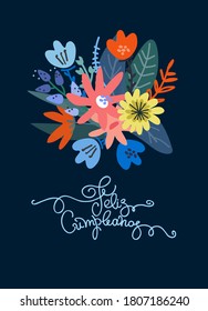 Birthday greeting card design. Text in Spanish says happy birthday. Lush floral bouquet and hand lettering. Isolated on dark blue