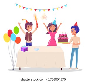 Birthday party. Happy teenagers celebrates standing at the festive table with gifts and birthday cake. The room is decorated with garlands and balls, boy carries cake with candles. Happy birthday
