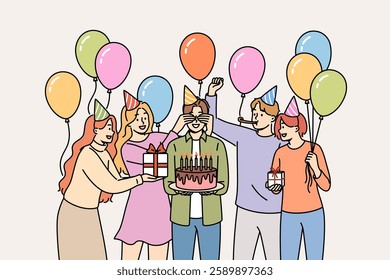 Birthday party for man celebrating anniversary and holding cake, standing among friends with balloons. Positive guys and girls congratulate friend on birthday and present gift boxes during fun party