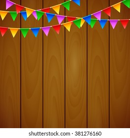 Birthday party with triangle flags on wooden background