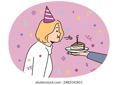 Birthday woman blows out candle on piece of cake celebrating anniversary and making cherished wish. Girl in birthday hat stands among confetti celebrating day of angel and dreaming about future