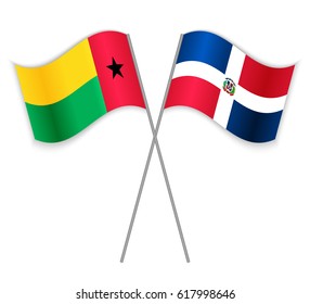 Bissau-Guinean and Dominican crossed flags. Guinea-Bissau combined with Dominican Republic isolated on white. Language learning, international business or travel concept.