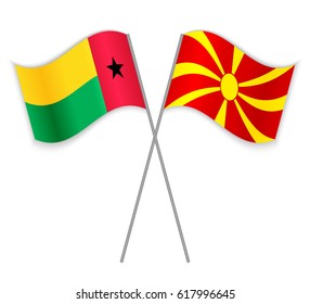 Bissau-Guinean and Macedonian crossed flags. Guinea-Bissau combined with Macedonia isolated on white. Language learning, international business or travel concept.