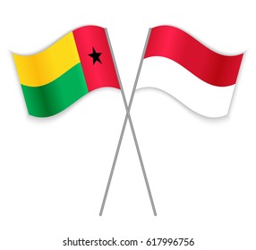 Bissau-Guinean and Monegasque crossed flags. Guinea-Bissau combined with Monaco isolated on white. Language learning, international business or travel concept.