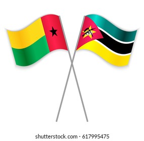 Bissau-Guinean and Mozambican crossed flags. Guinea-Bissau combined with Mozambique isolated on white. Language learning, international business or travel concept.