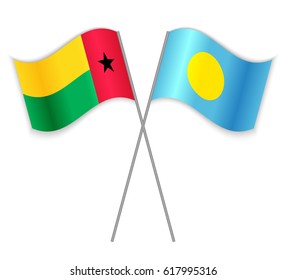 Bissau-Guinean and Palauan crossed flags. Guinea-Bissau combined with Palau isolated on white. Language learning, international business or travel concept.