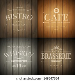 Bistro, cafe, brasserie and whiskey emblem templates on wooden background. Vector illustration.