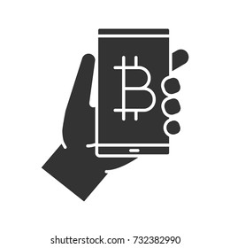 Bitcoin digital wallet glyph icon. Cryptocurrency. Silhouette symbol. Hand holding smartphone with bitcoin sign. Negative space. Vector isolated illustration