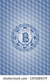 bitcoin icon inside blue badge with geometric pattern.
