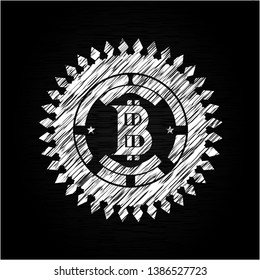 bitcoin icon inside chalk emblem written on a blackboard