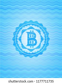 bitcoin icon inside sky blue water wave badge.