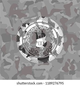 bitcoin icon on grey camouflaged pattern