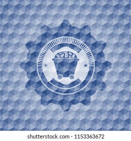 Bitcoin mining trolley icon inside blue emblem with geometric background.