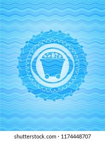 Bitcoin mining trolley icon inside water wave style badge.
