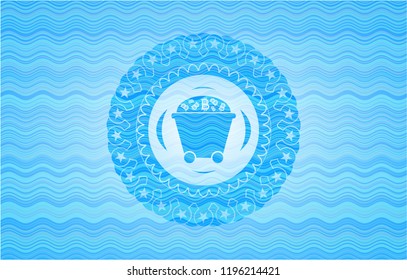 Bitcoin mining trolley icon inside sky blue water wave emblem background.