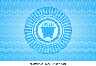 Bitcoin mining trolley icon inside sky blue water wave emblem.