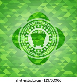 Bitcoin mining trolley icon inside green emblem. Mosaic background