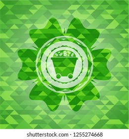 Bitcoin mining trolley icon inside green emblem with triangle mosaic background
