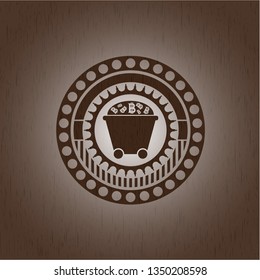 Bitcoin mining trolley icon inside badge with wood background