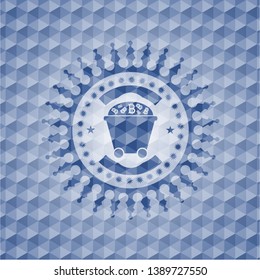 Bitcoin mining trolley icon inside blue emblem with geometric pattern background.