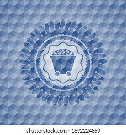 Bitcoin mining trolley icon inside blue badge with geometric background.
