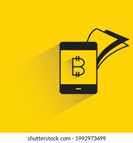 bitcoin payment on smartphone with shadow on yellow background