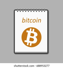Bitcoin sign on a sheet in a notebook