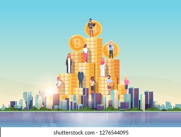 bitcoin virtual money people standing at golden coins stack crypto currency mining concept over big modern city building skyscraper cityscape skyline flat horizontal