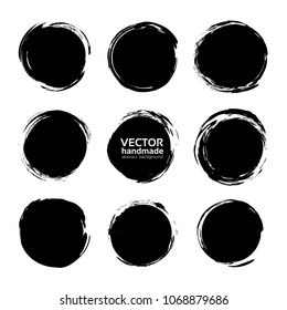 Black abstract textured circle smears isolated on a white background