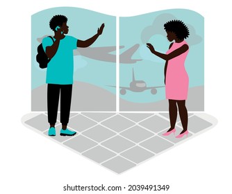 A black African American couple break up in an airport terminal. They waving goodbye to each other.
