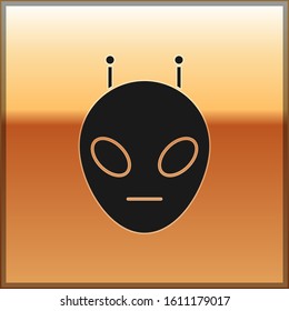 Black Alien icon isolated on gold background. Extraterrestrial alien face or head symbol.  Vector Illustration