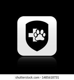 Black Animal health insurance icon isolated on black background. Pet protection icon. Dog or cat paw print. Silver square button. Vector Illustration