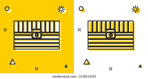 Black Antique treasure chest icon isolated on yellow and white background. Vintage wooden chest with golden coin. Random dynamic shapes. Vector Illustration