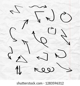 Black arrows are drawn on the background of a crumpled sheet of notebook