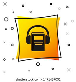 Black Audio book icon isolated on white background. Book with headphones. Audio guide sign. Online learning concept. Yellow square button. Vector Illustration