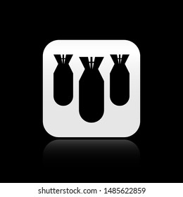 Black Aviation bombs icon isolated on black background. Rocket bomb flies down. Silver square button. Vector Illustration