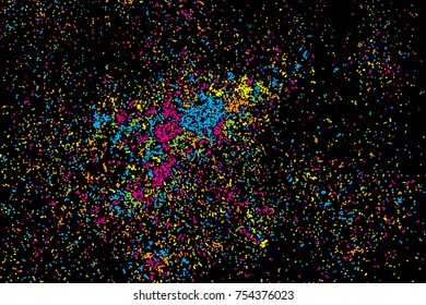 Black background with many falling tiny round random confetti, glitter and serpentine pieces blow and sprayed on black background. Isolated.